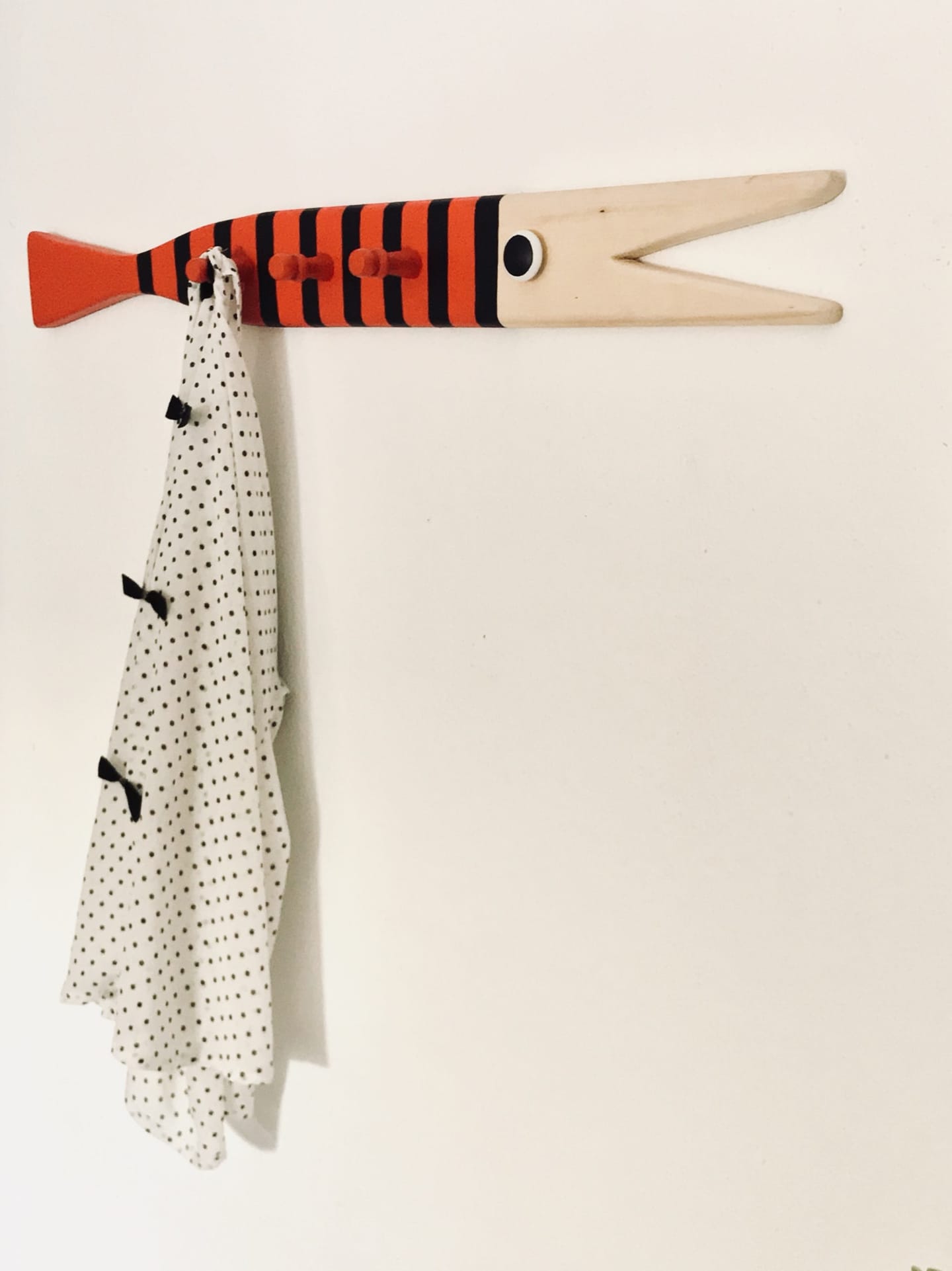 Striped wooden fish hook with a towel