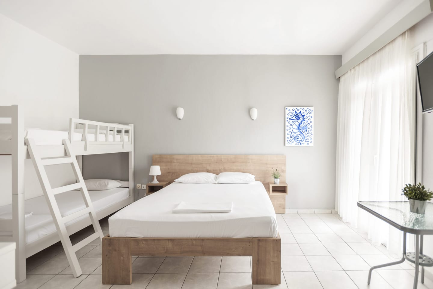 Studio with double bed, bunk bed and blue artwork
